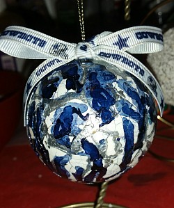 Ornament covered with pieces of eggshells and drizzled with alcohol ink