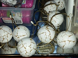 Paper mache ornaments covered in eggshells and ready to be painted.