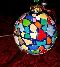 Glass ornament with colorful eggshell pieces.