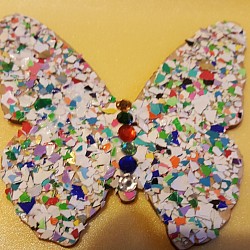 Wooden butterfly with painted eggshell pieves.