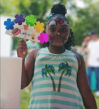 This was when I lwas at the Hope Center festival in 2016. This young lady made a fan feom a half paper plate and applied foam flowers..